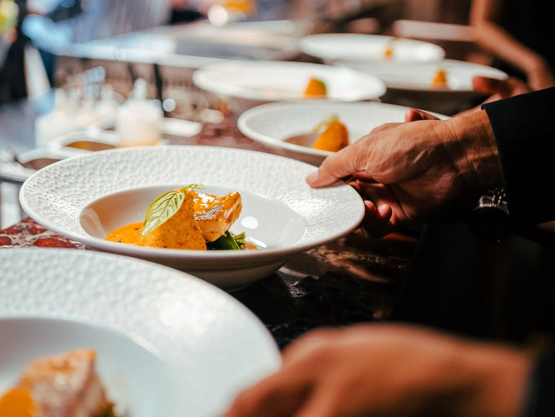 Brontë service team presenting dishes from the kitchen pass